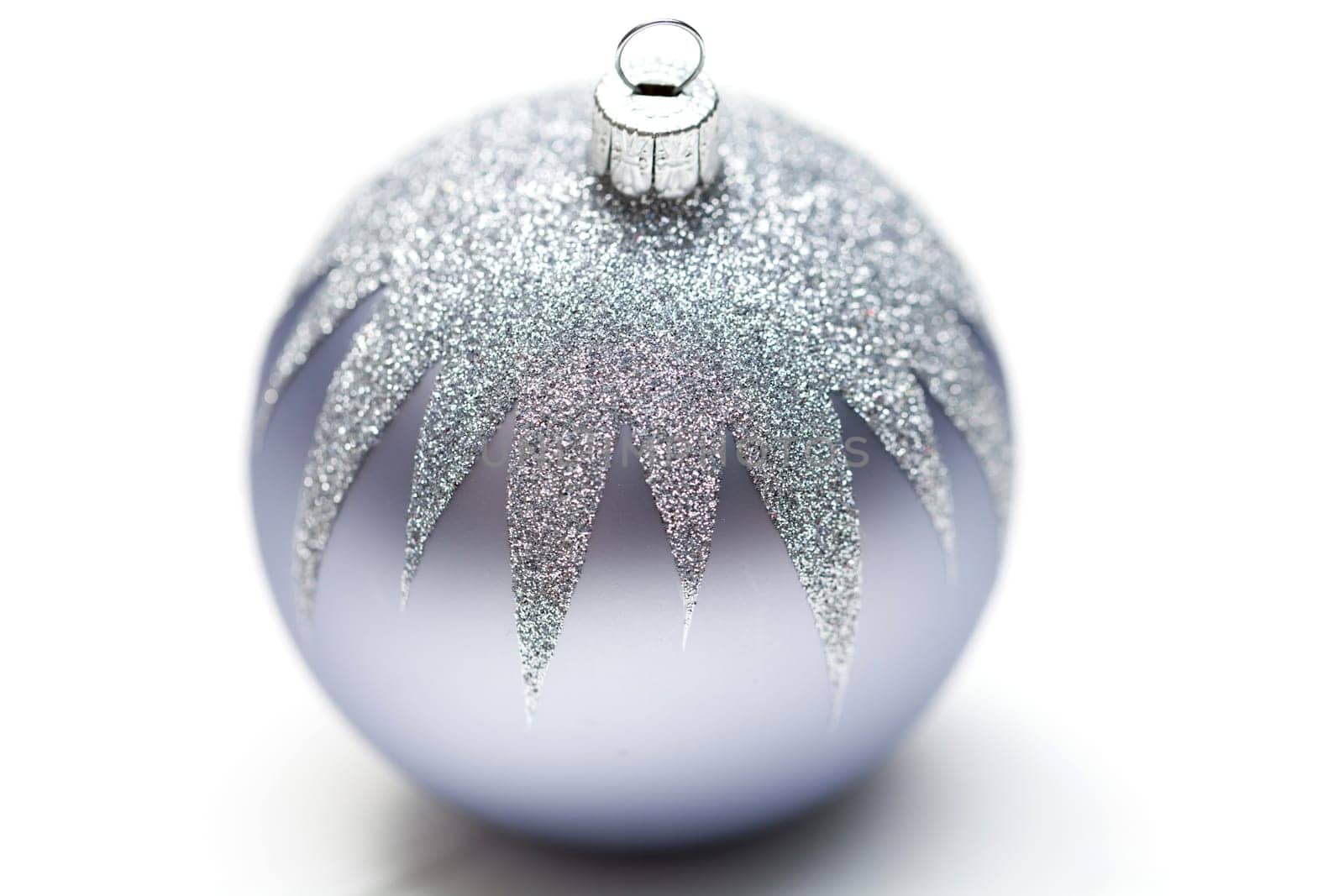 Glittering silver Christmas bauble on white background Macro detail