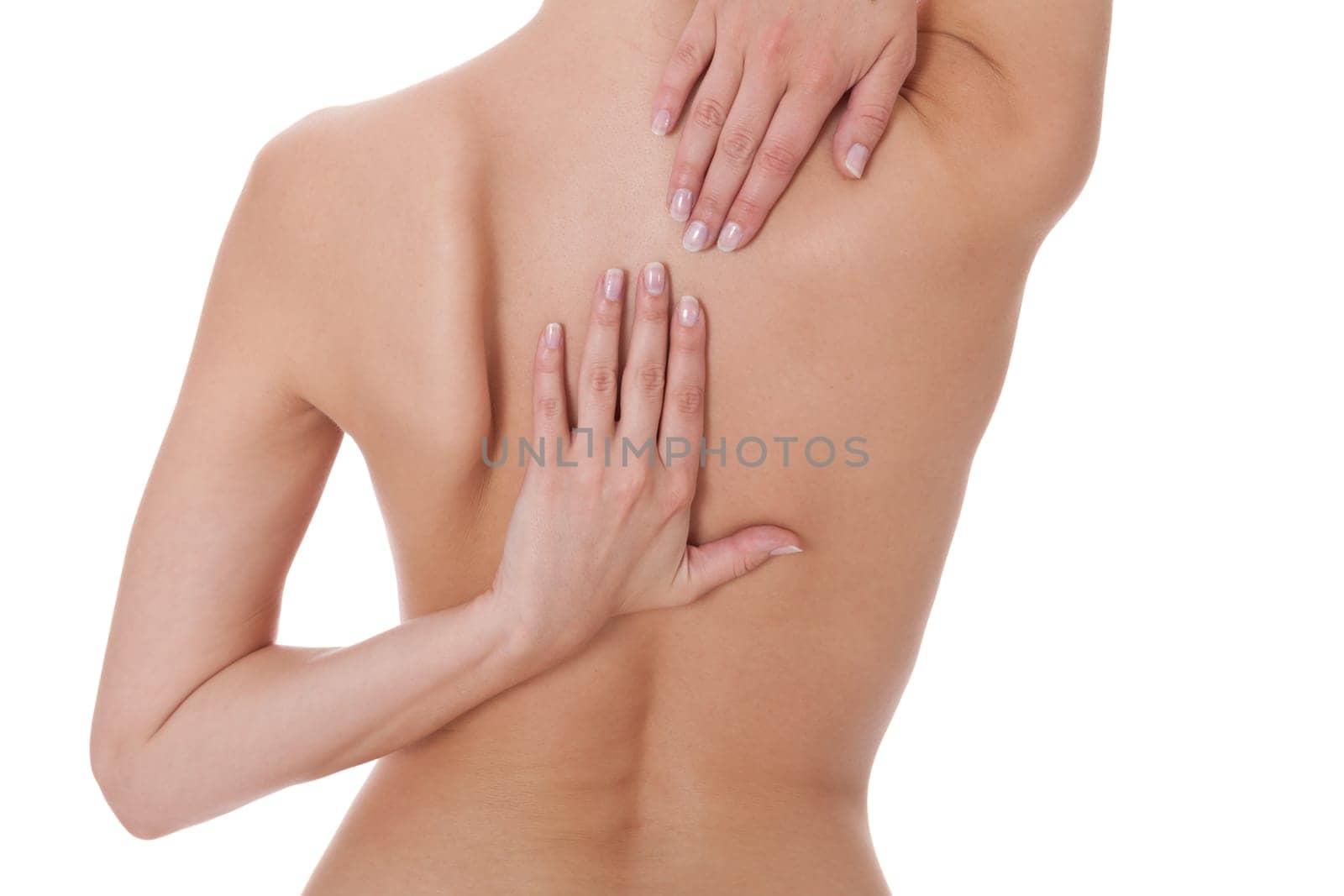 Young attractive woman grabs with her hands on her back bodypart isolated voe white background
