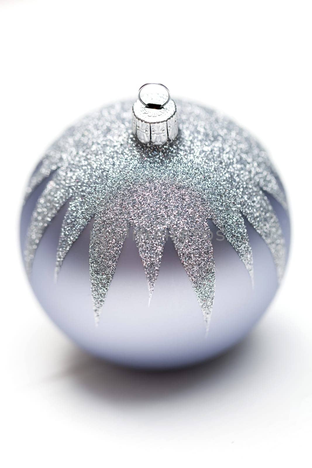 Glittering silver Christmas bauble on white background Macro detail