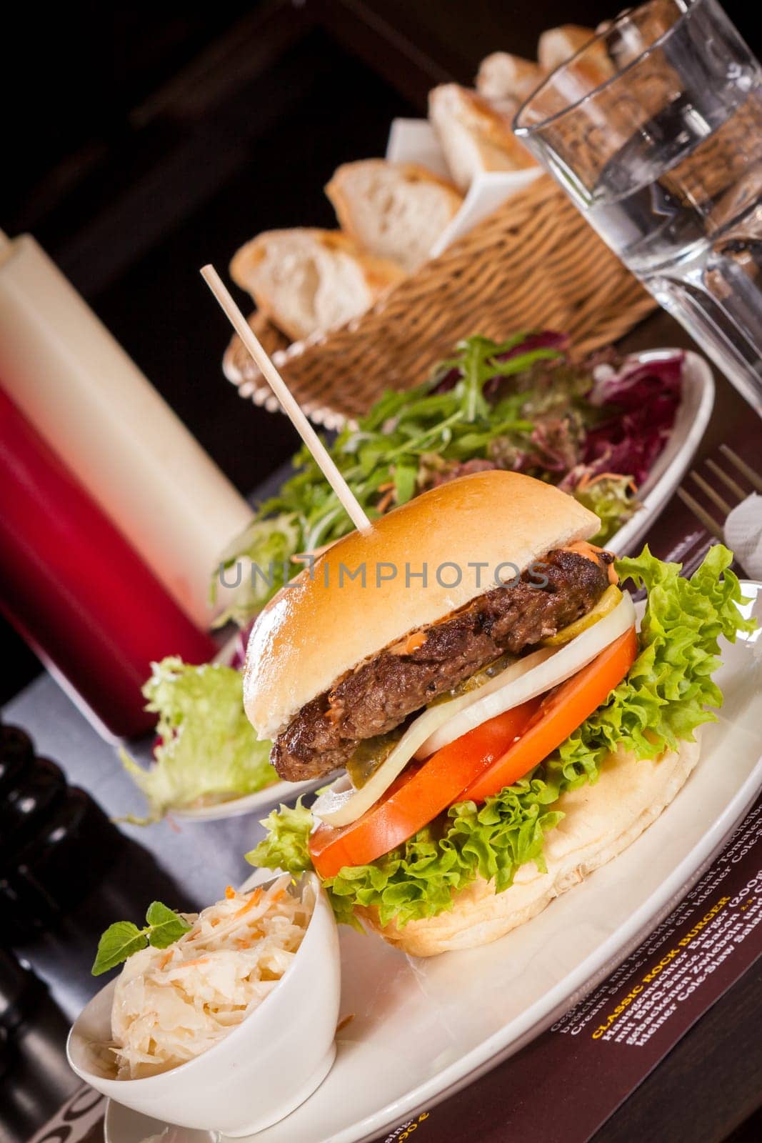 Delicious hamburger cheeseburger with bacon egg and salad on a plate