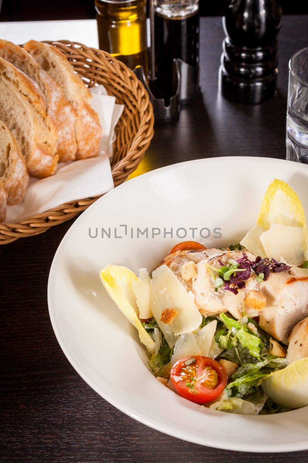 Fresh delicious caesarsalat with grilled chicken bust parmesan splinters and croutons