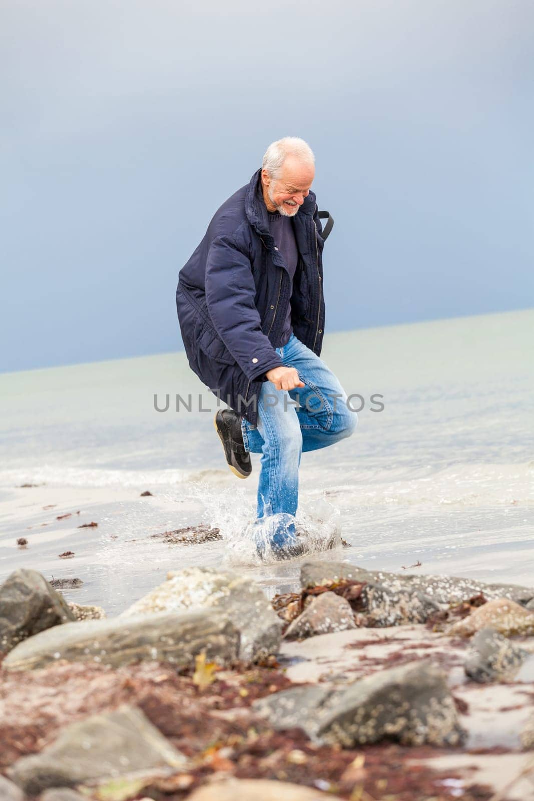 older adult happy couple walks on the beach in autumn lifestyle happiness