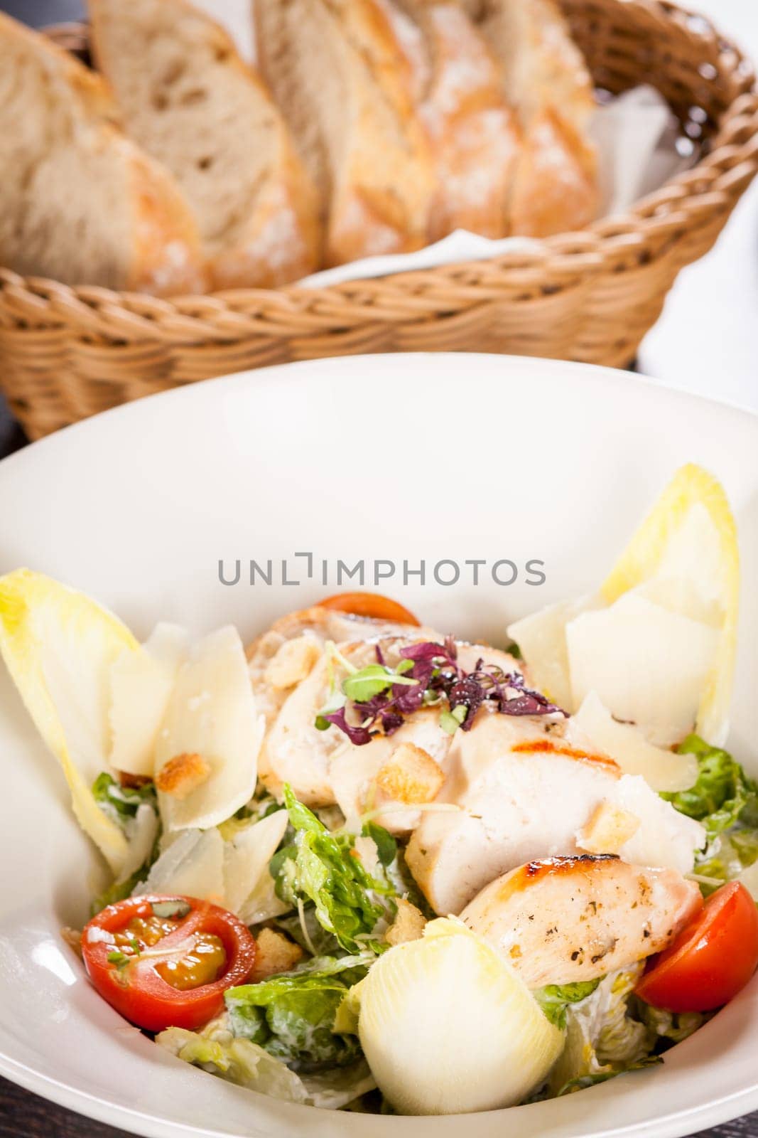 Fresh delicious caesarsalat with grilled chicken bust parmesan splinters and croutons