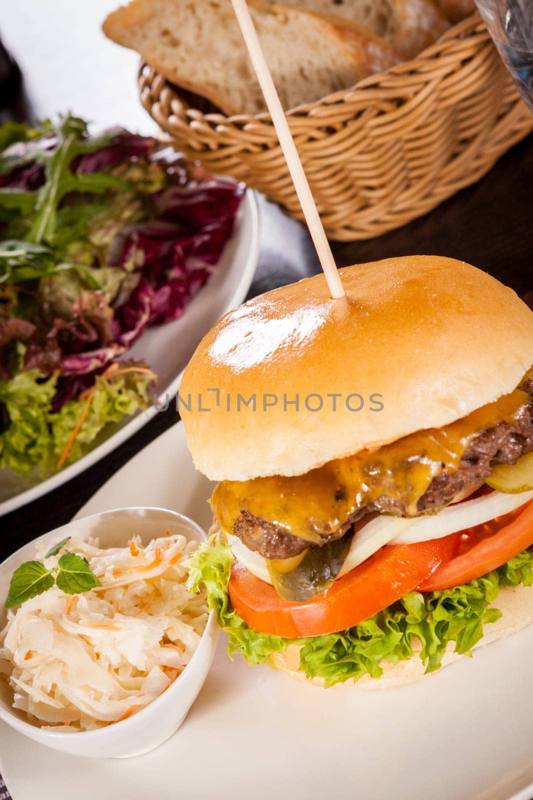 Delicious hamburger cheeseburger with bacon egg and salad on a plate