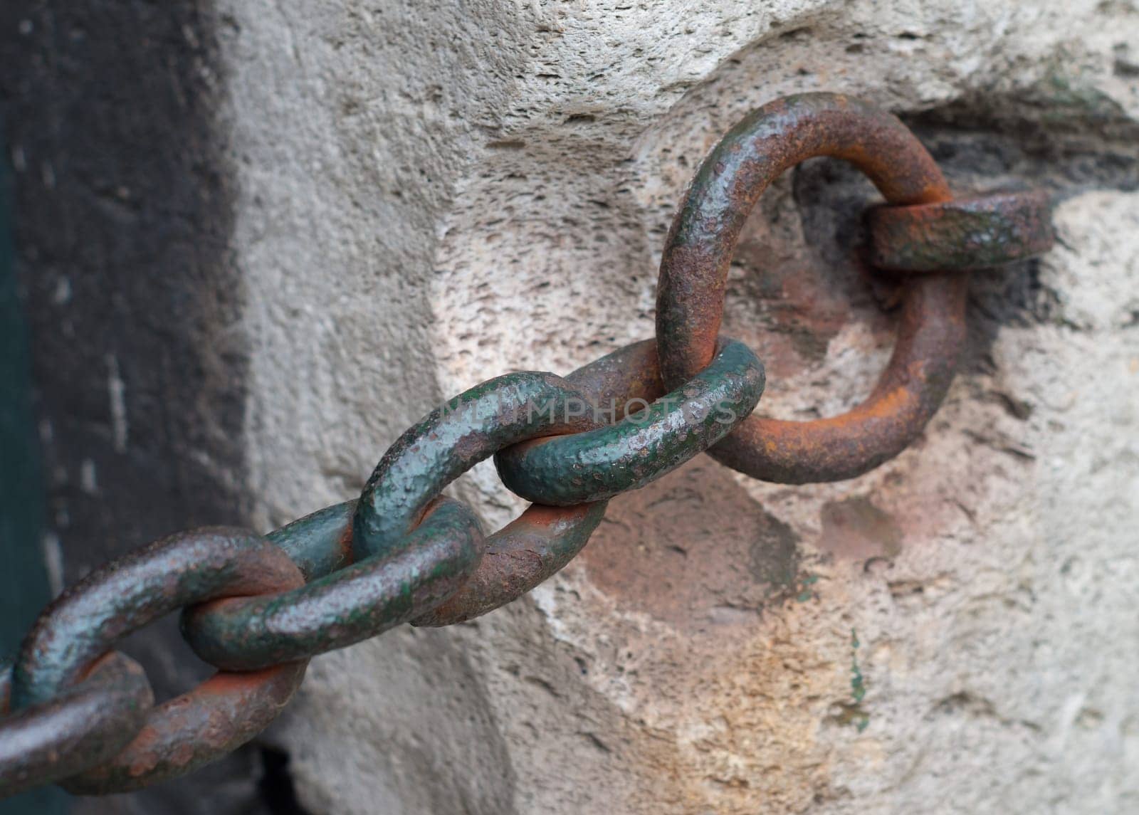 rusty old chain at a wall