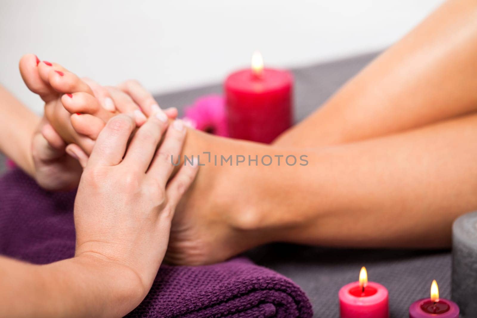 Woman with pedicure in a beauty salon on a towel with lactated toe nails