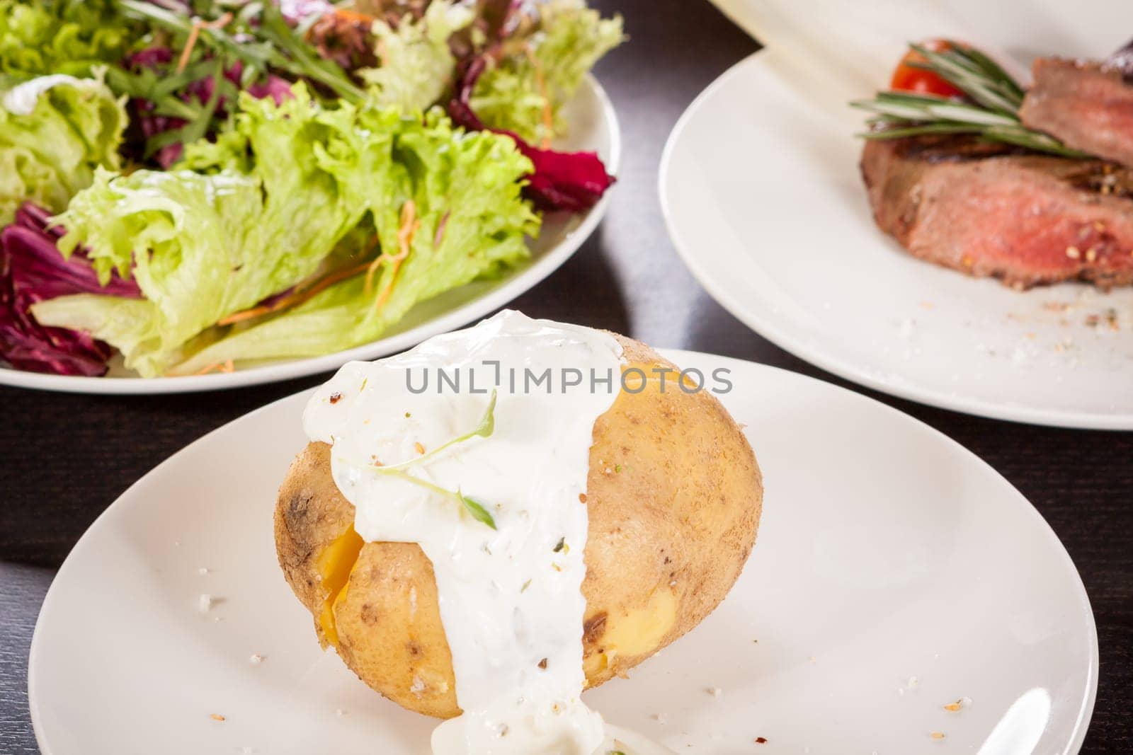 fresh foilpotato from the oven with herb quark sour cream and fresh herbs