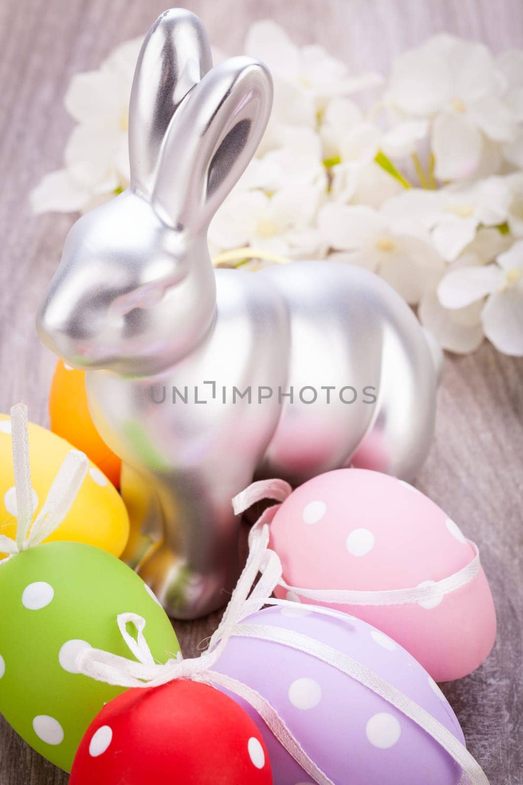 Colourful yellow and red Tulip with Easter eggs decorated at Easter with text space on green background