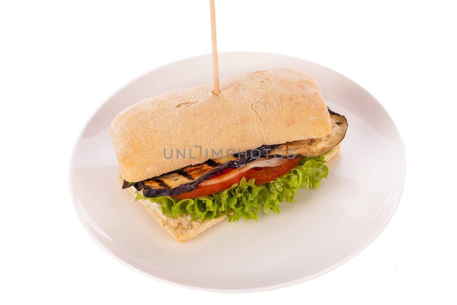 Vegetarian vegan hamburger with aubergine tomato and salad in a ciabatta bun isolated on a white background