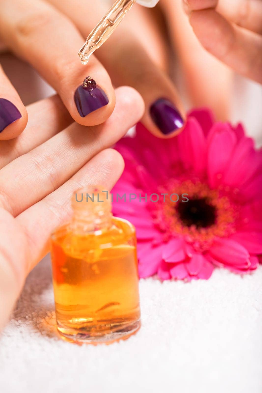 Professional nail designer at a manicure with female hands in a nail salon