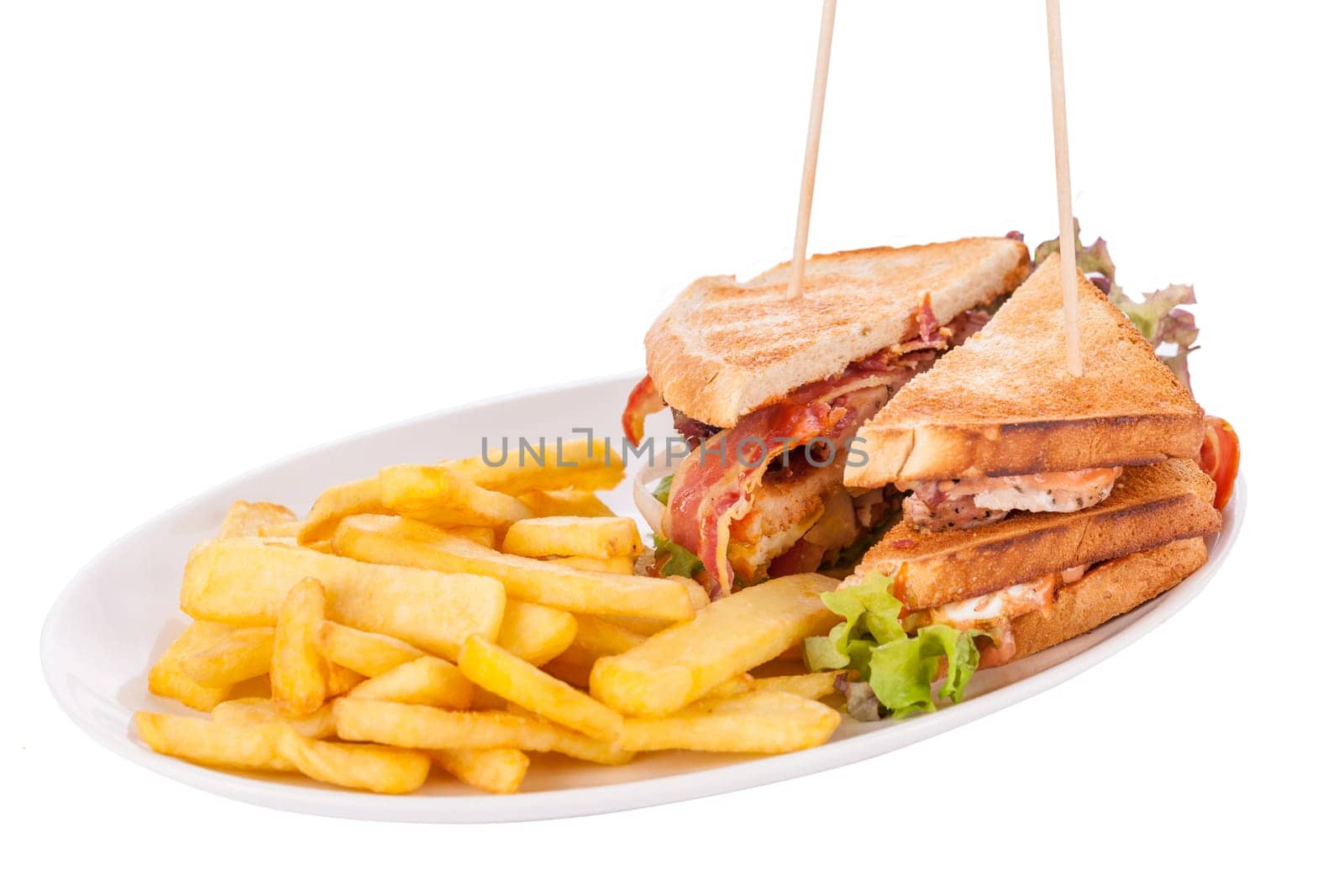 Club sandwich on toasted white bread with bacon and fries fried fries on a plate isolated against a white background