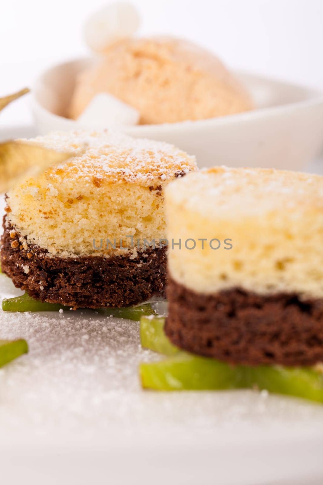 Brownie chocolate brownie with ice cream and plums prepared on a plate insulated against a white background
