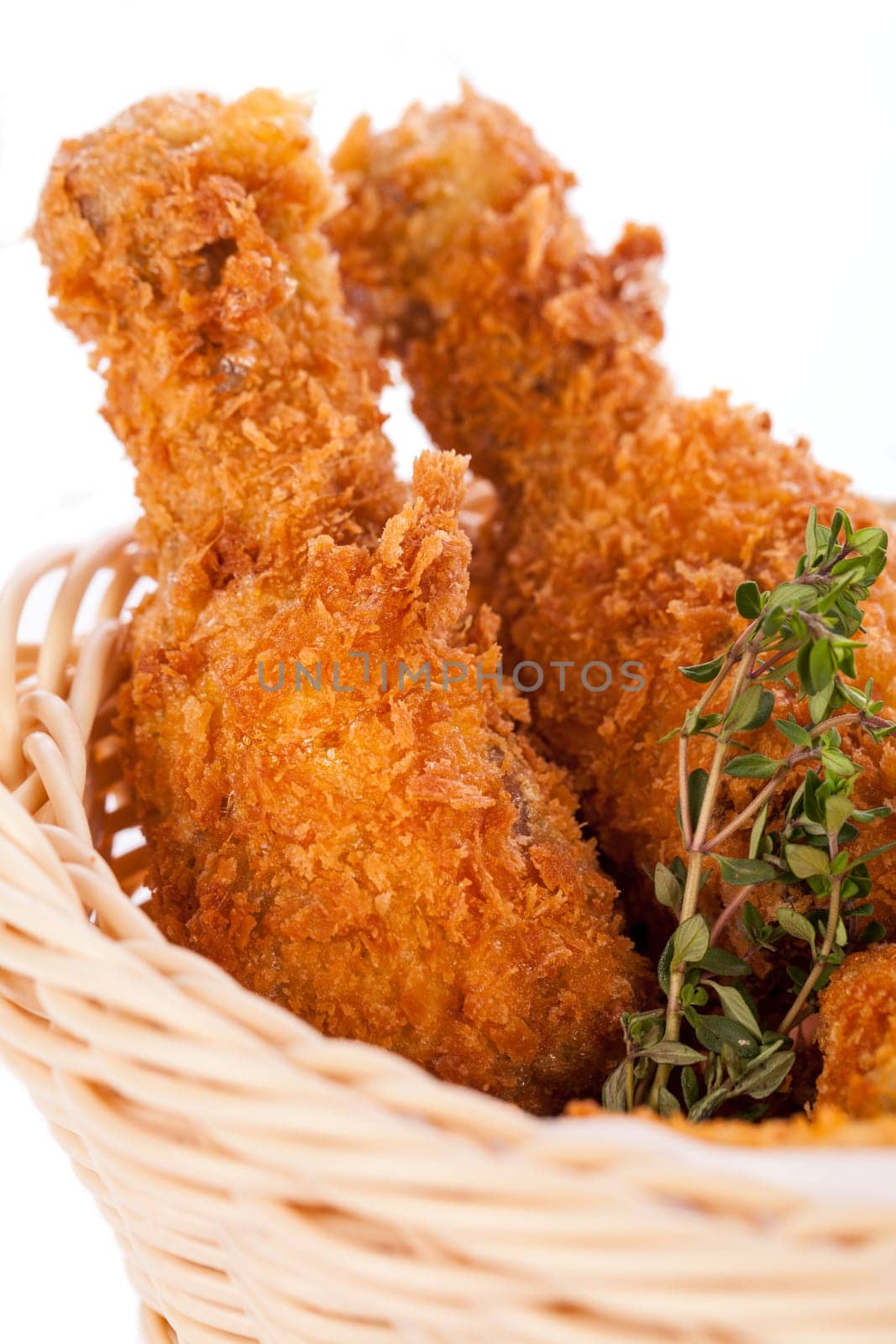 Crispy fried chicken wings with a dip on a plate insulated against a white background