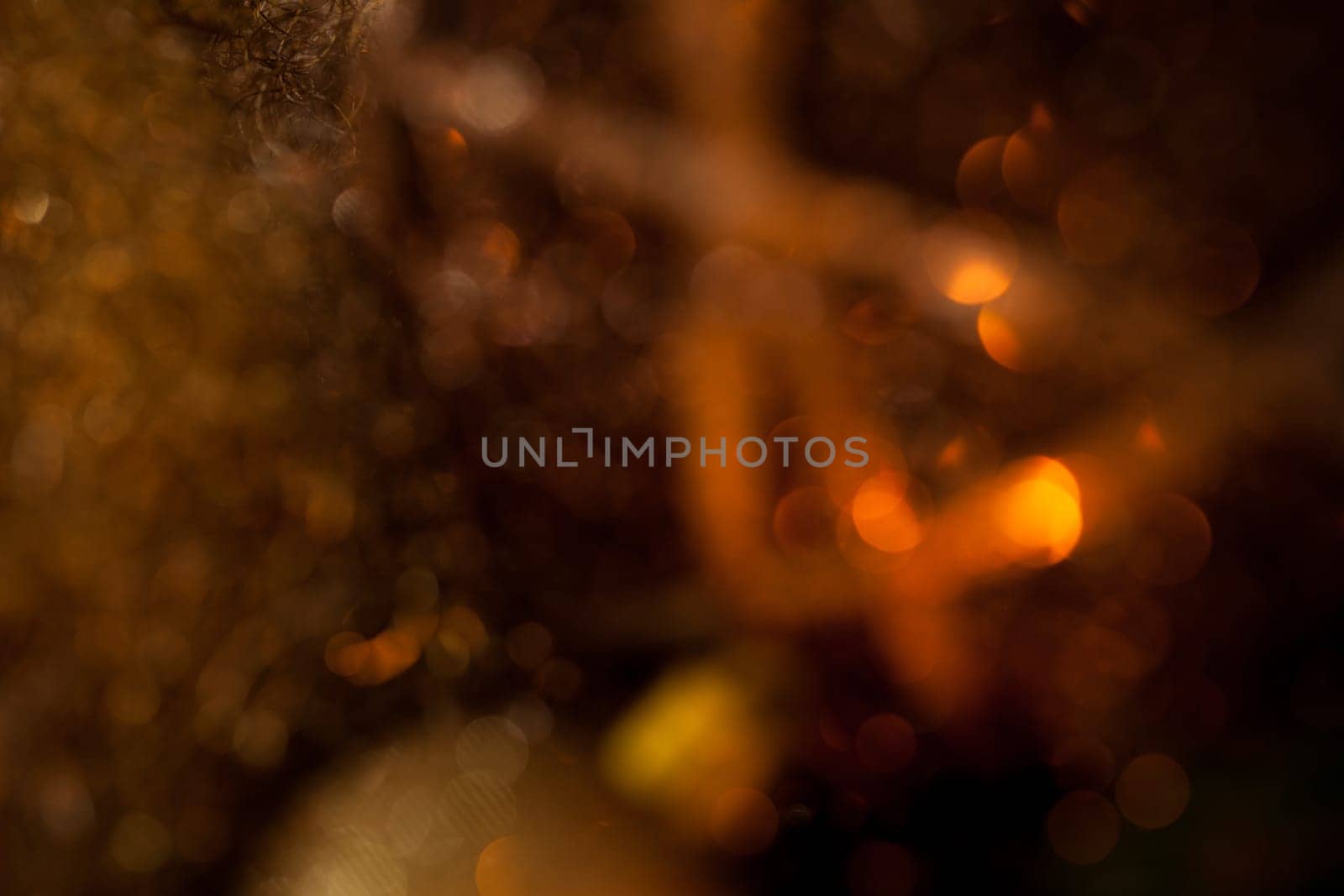Warm golden and orange Christmas decoration with candlelight as close-up in context