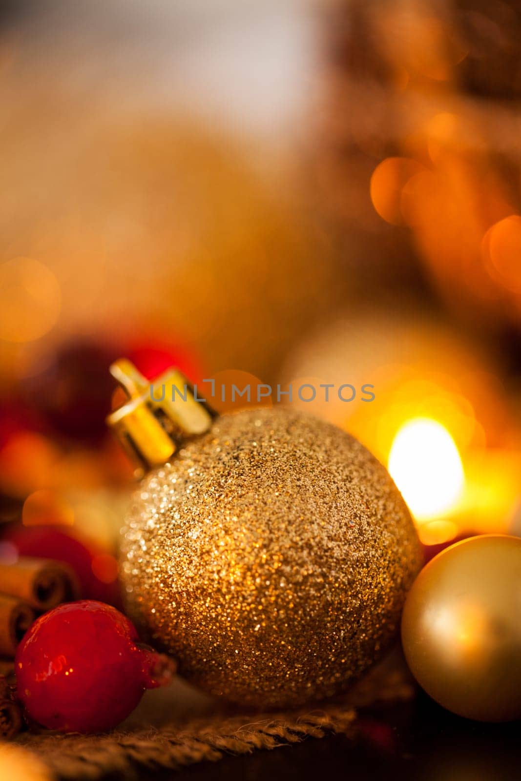 Warm golden and orange Christmas decoration with candlelight as close-up in context