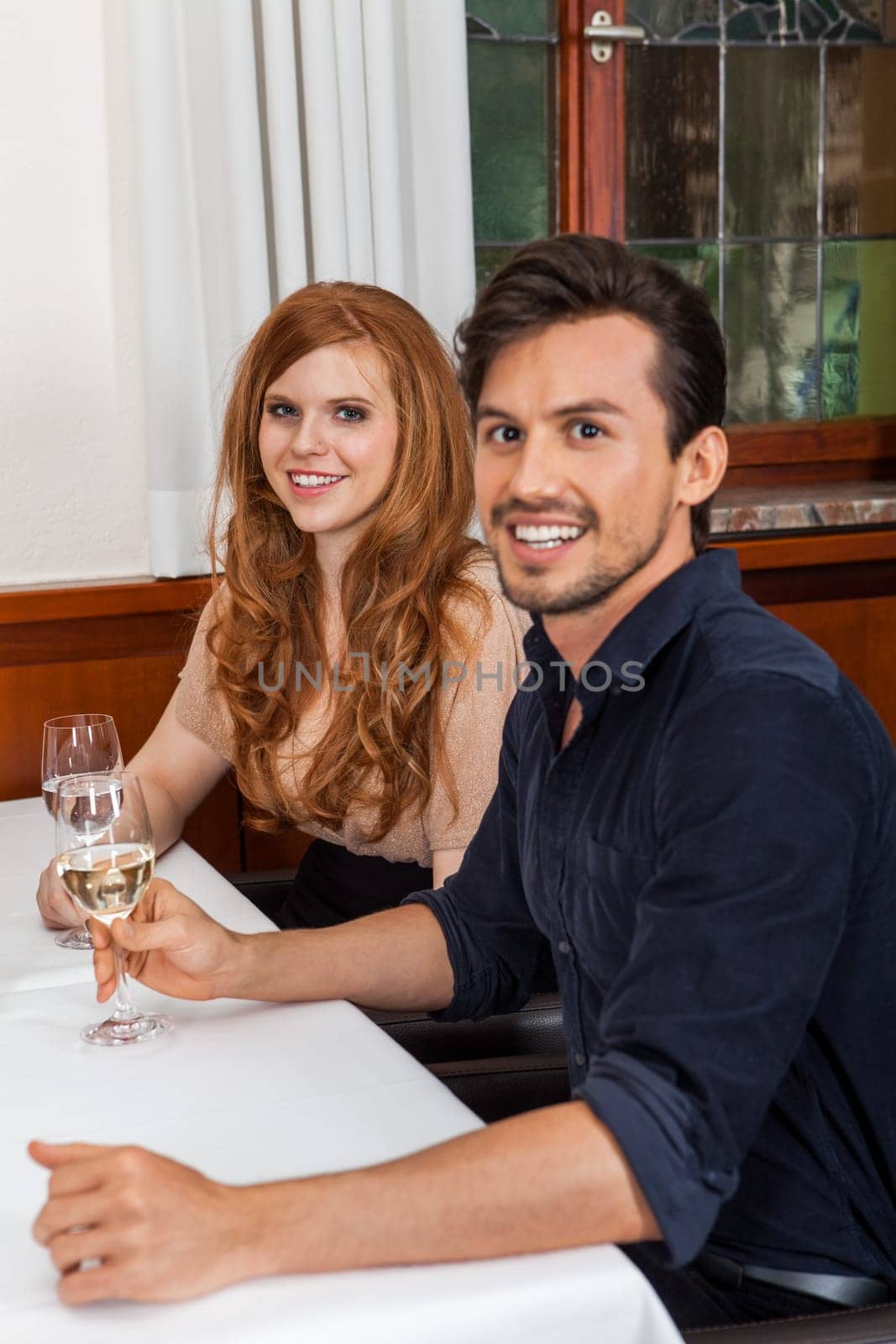 Young couple group in a restaurant cheerful while drinking
