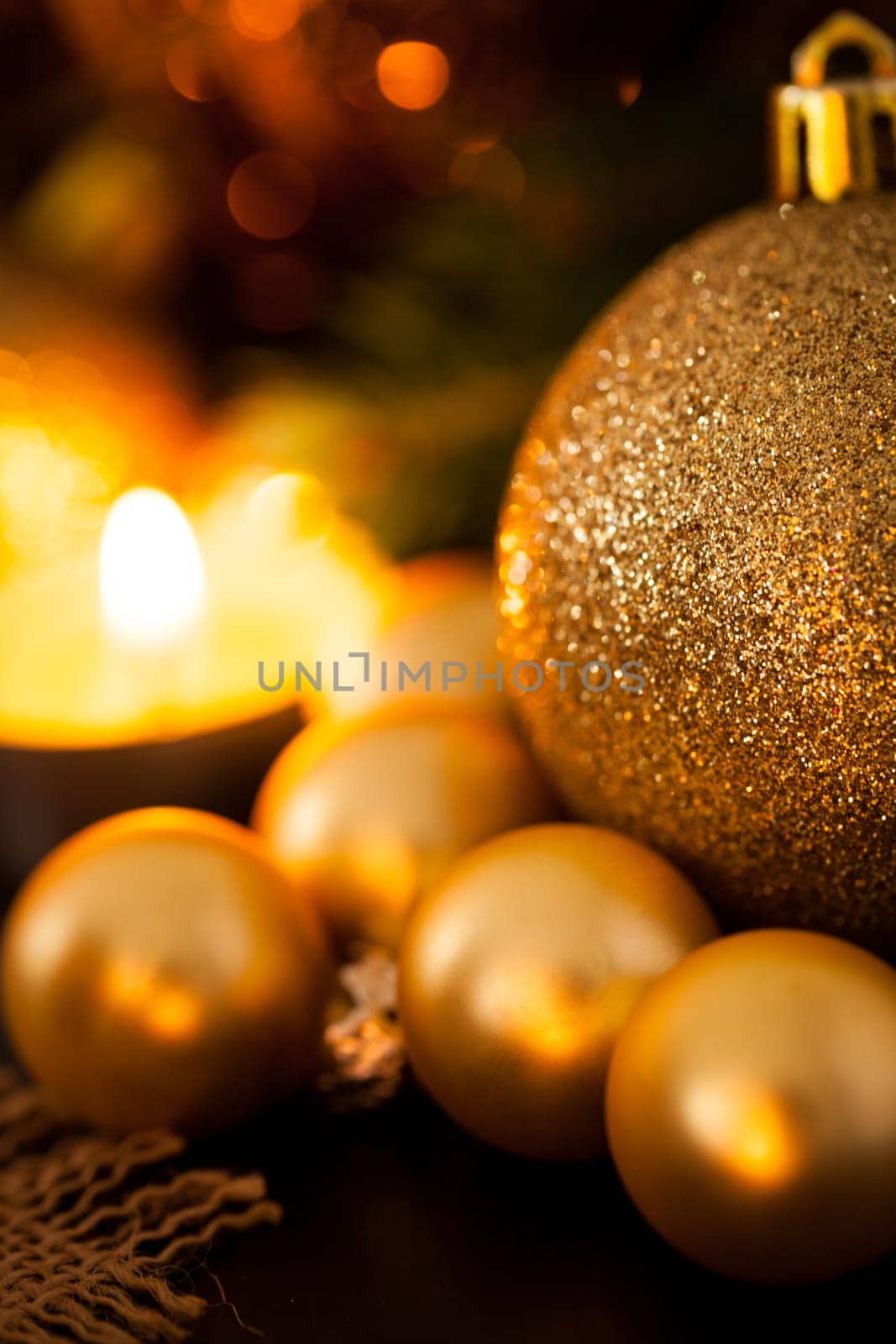 Warm golden and orange Christmas decoration with candlelight as close-up in context