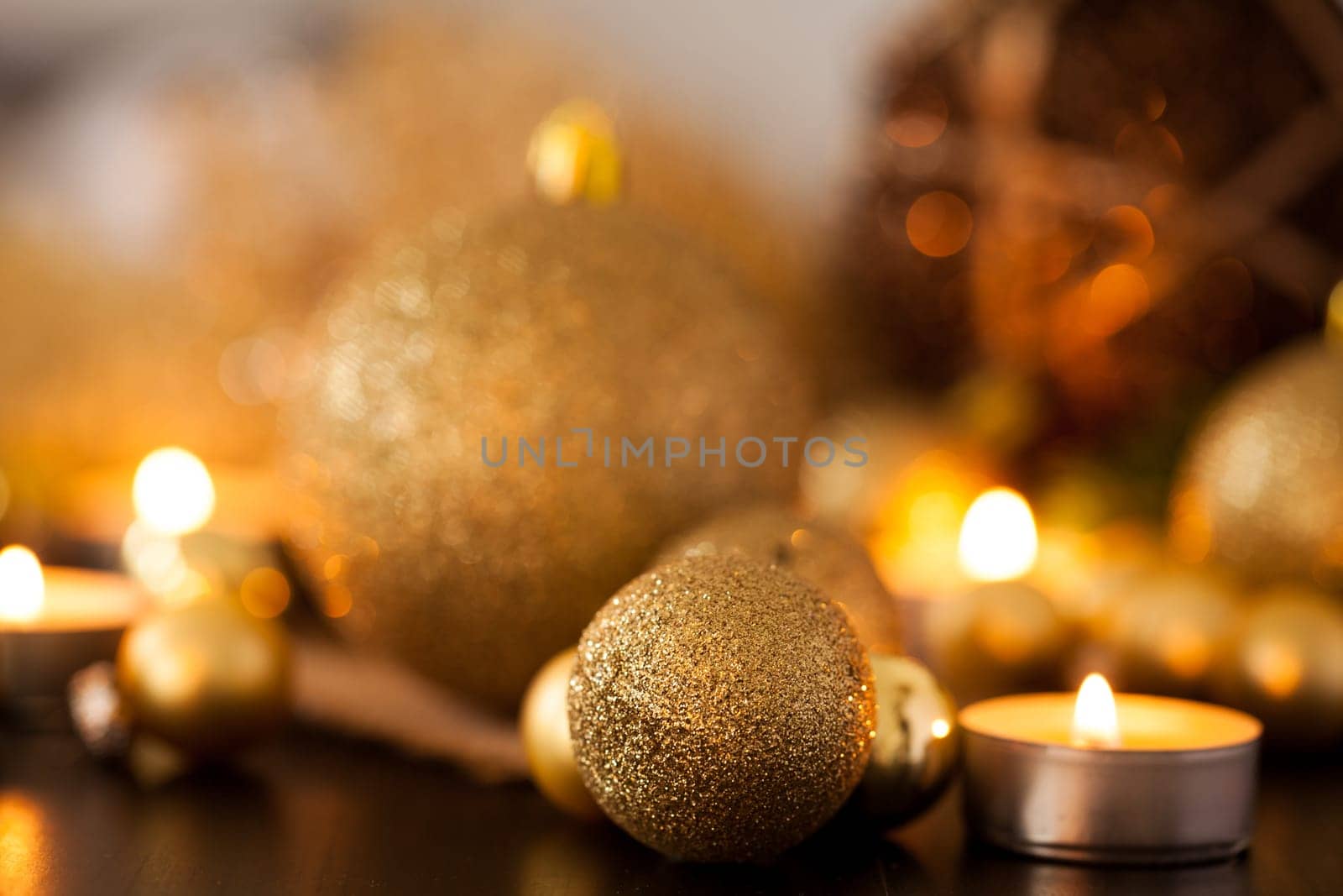 Warm golden and orange Christmas decoration with candlelight as close-up in context