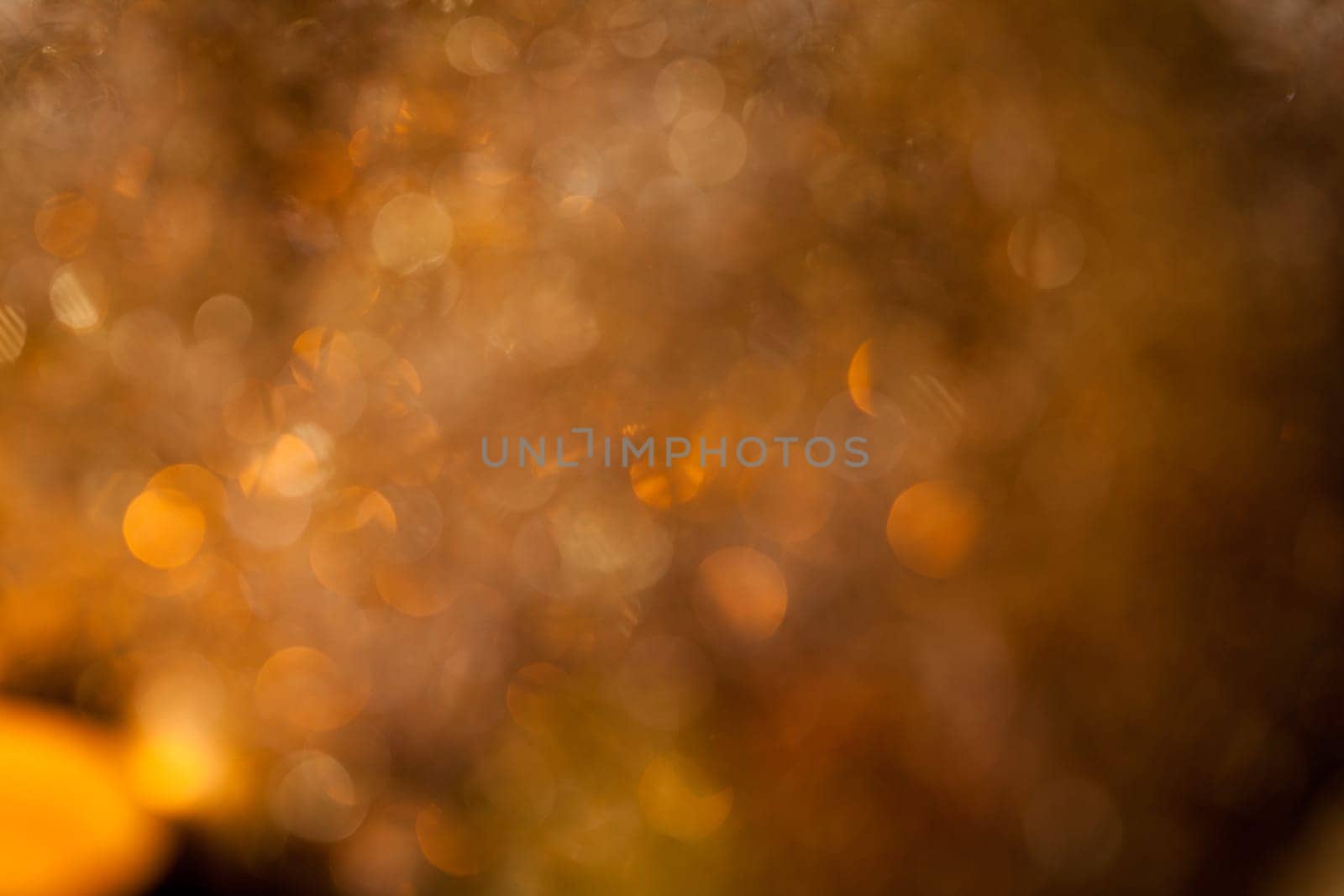Warm golden and orange Christmas decoration with candlelight as close-up in context