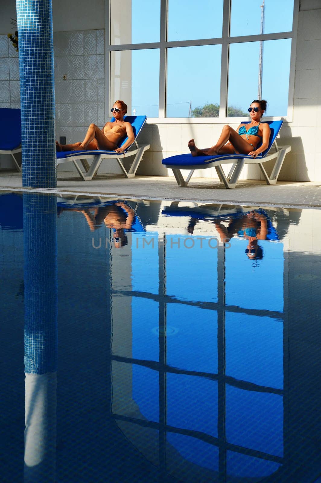 Two young women at the swimming pool.