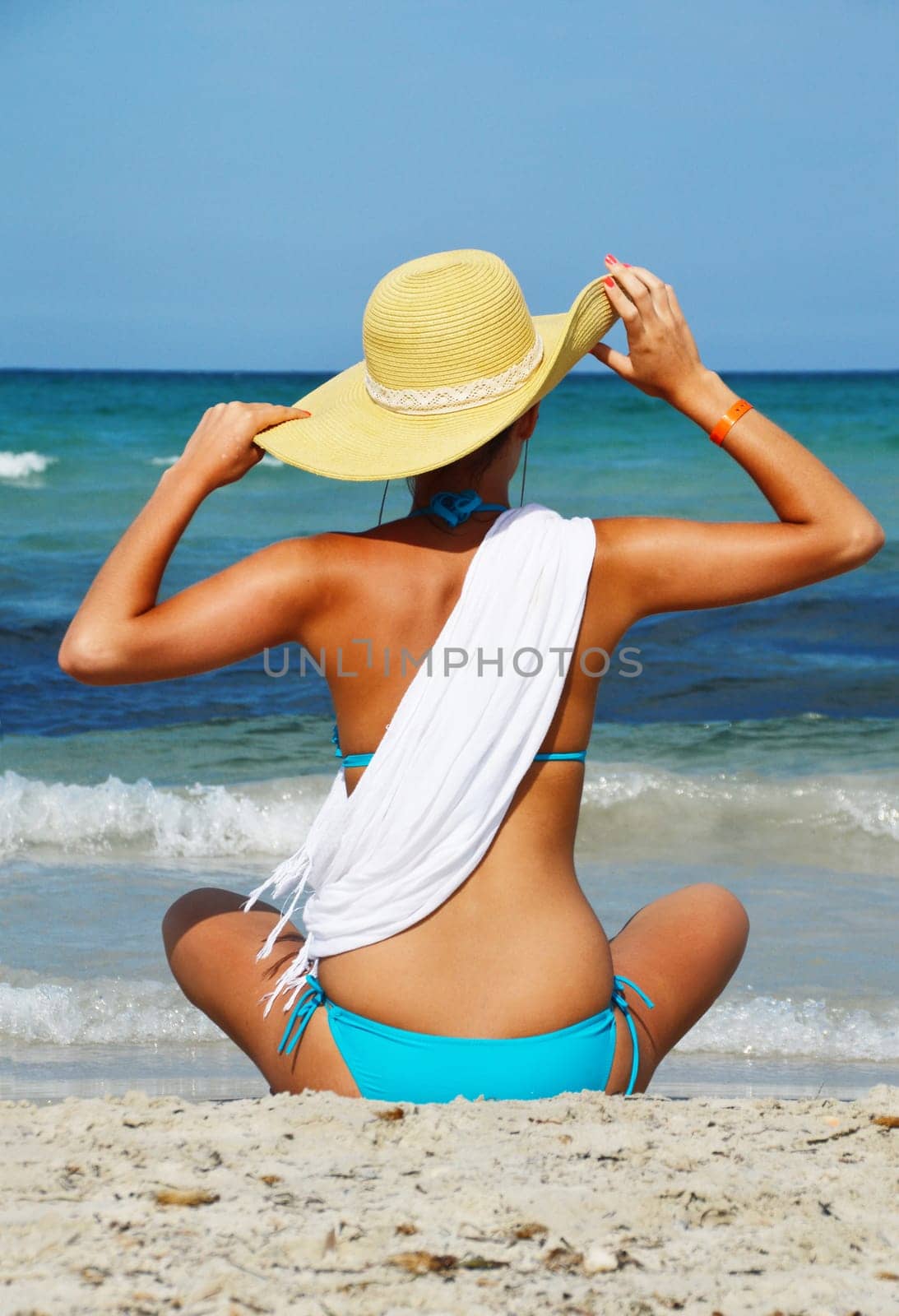 Young woman on the mediterranean beach during hot summer day