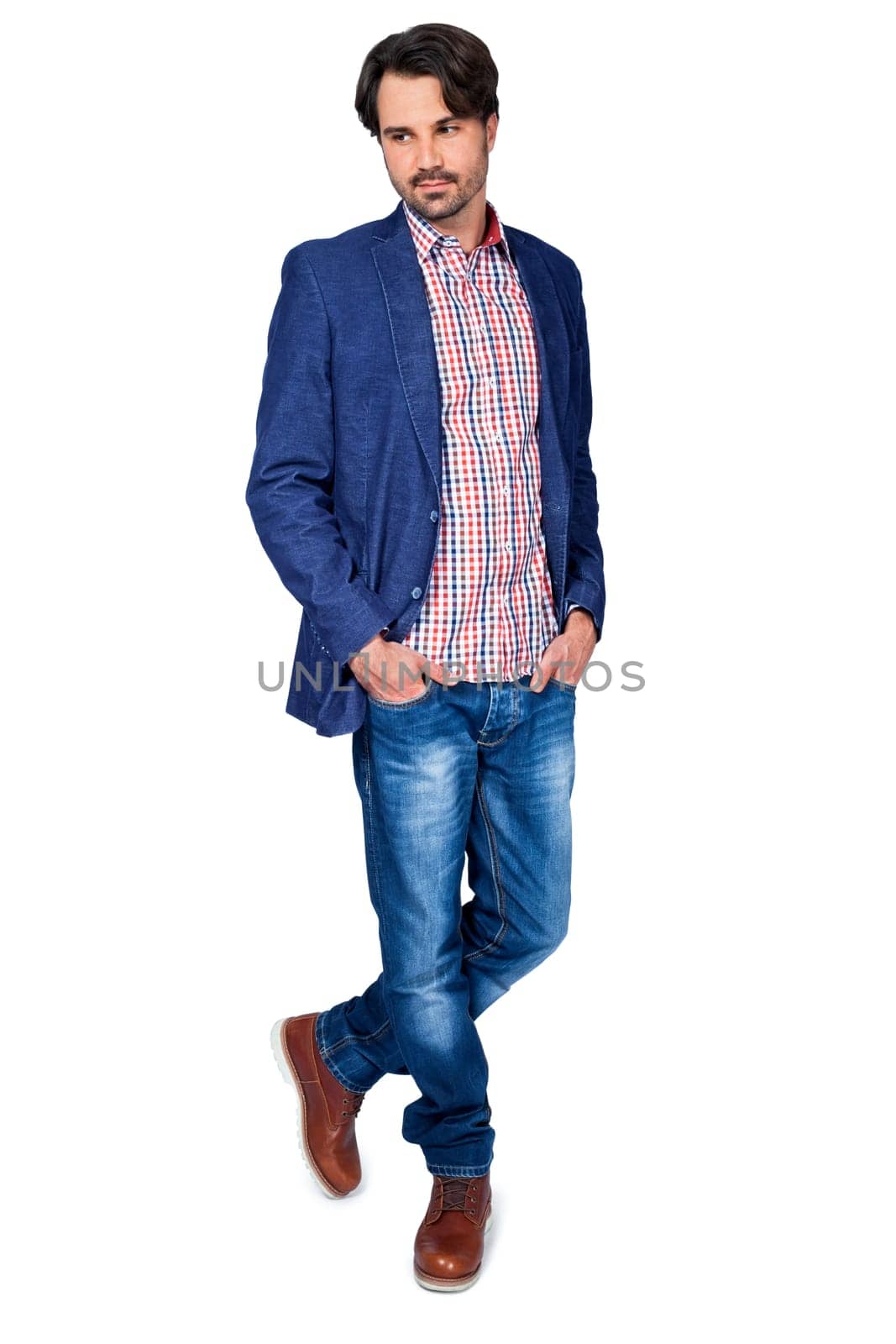 Young man in trendy casual look with dark hair and beard isolated against a white background