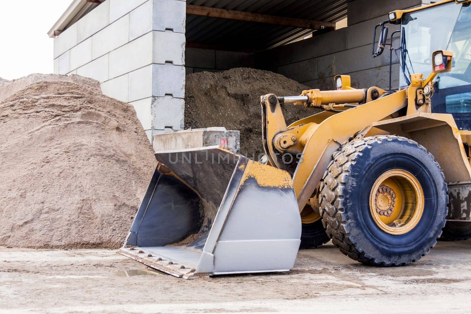 Shovel loader wheel loader with large shovel in the construction industry in the open air in daylight