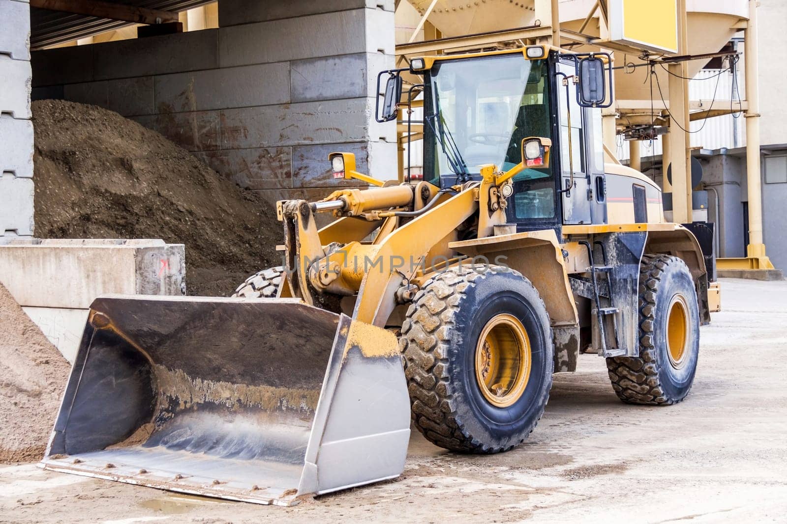 Shovel loader wheel loader with large shovel in the construction industry in the open air in daylight