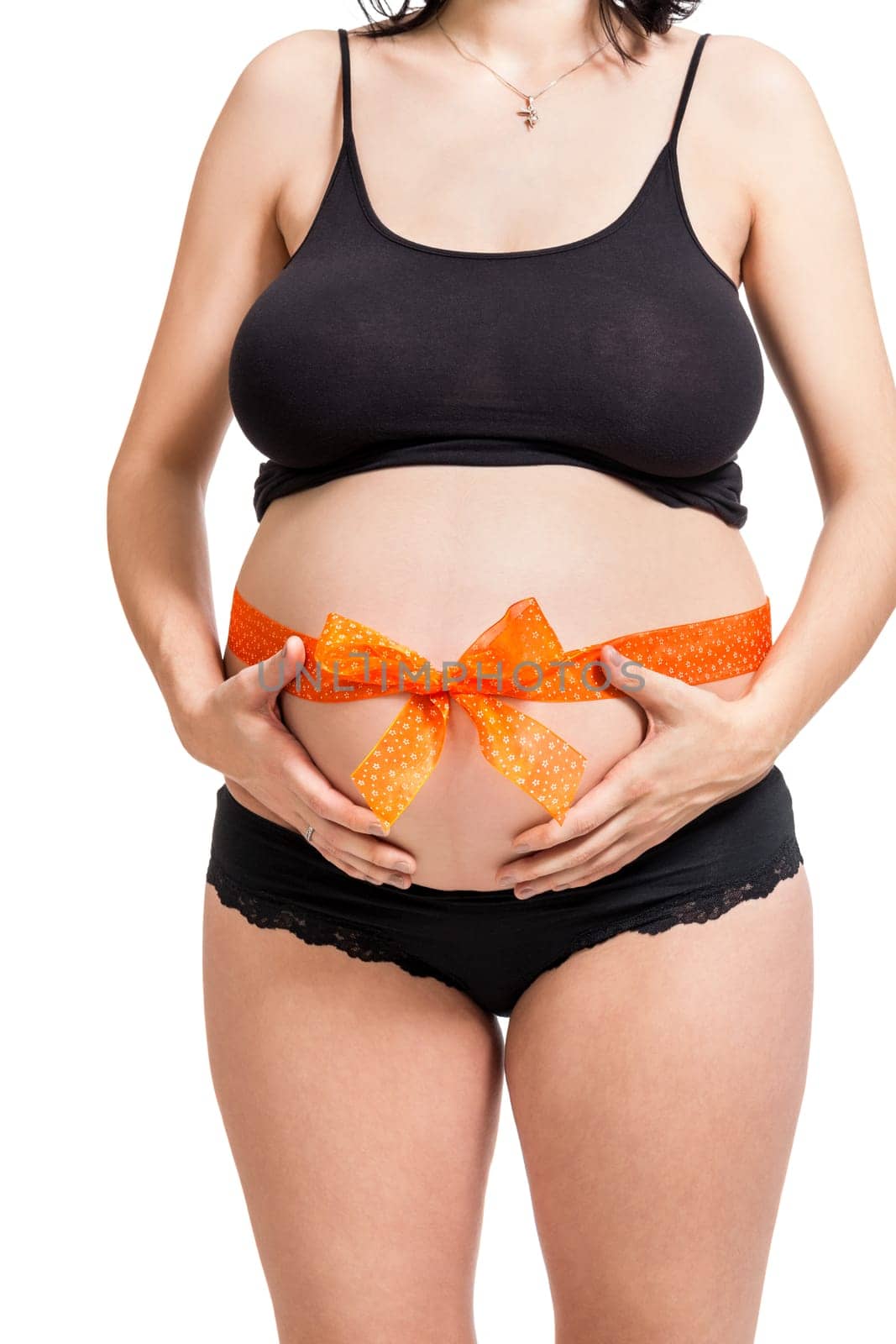 Young pregnant woman with orange bow around her belly as close-up isolated against white background