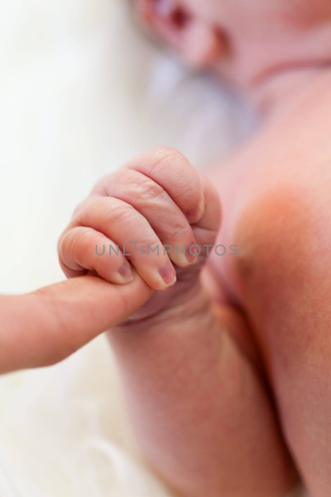 Little baby toddler newborn naked on a white fur as Detal