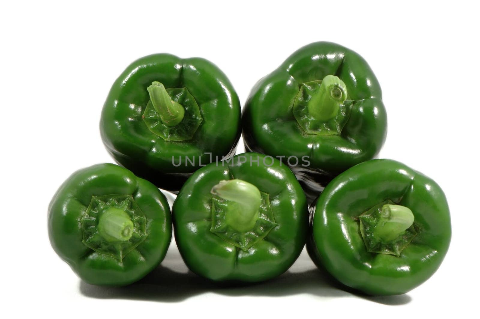 Stack of green papricas isolated over white