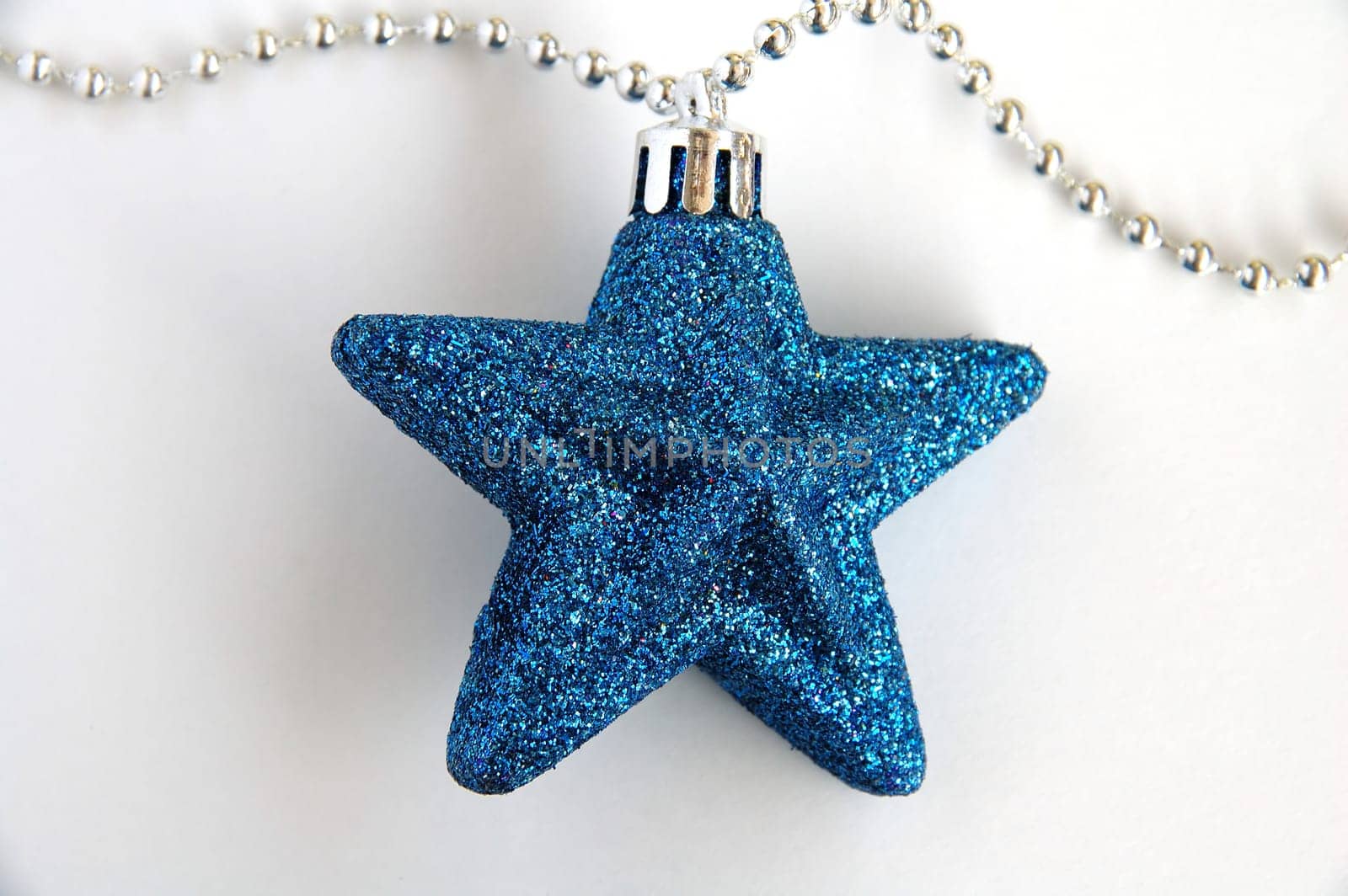 A blue ornamental christmas star with white background
