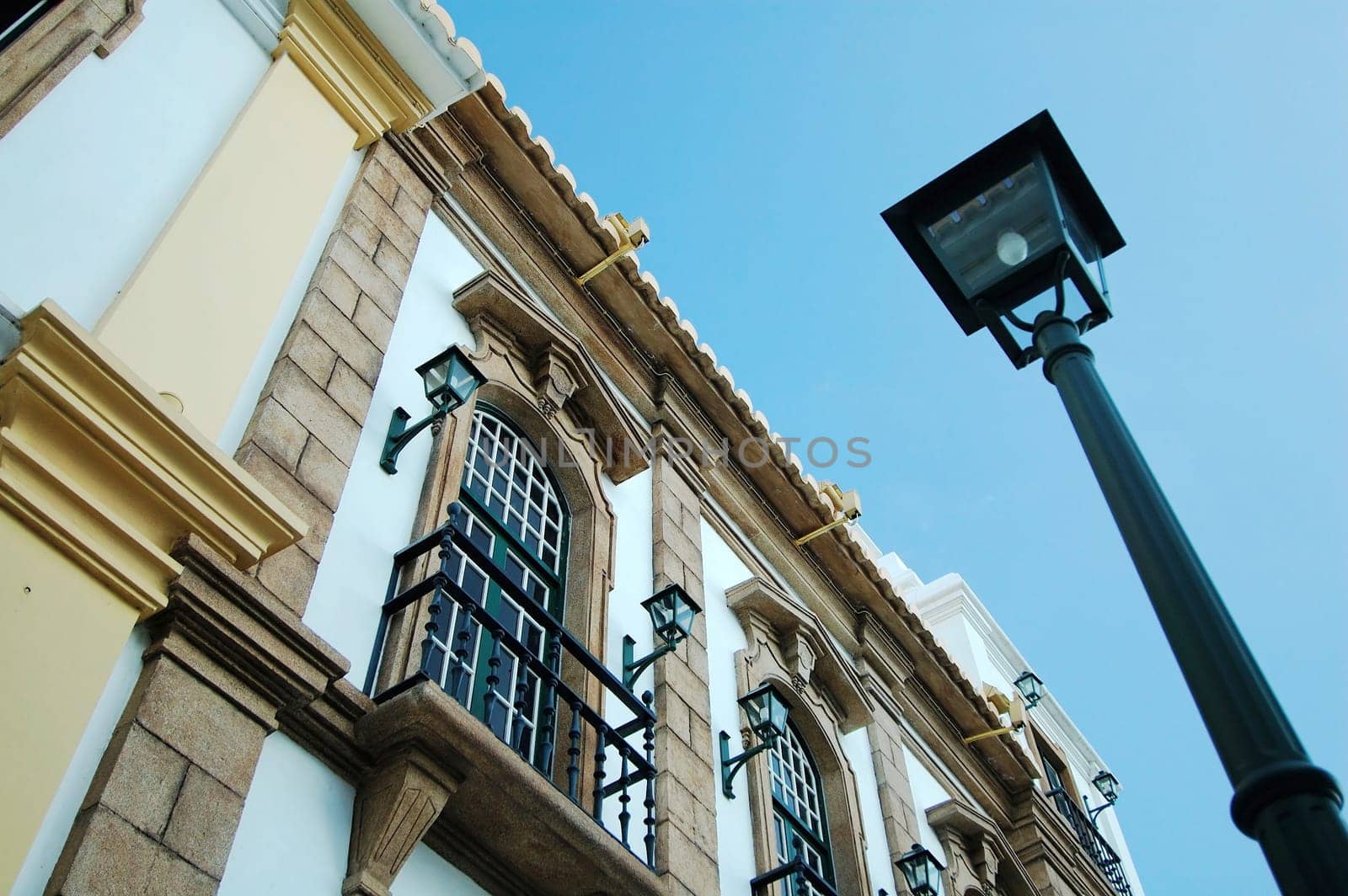 A view of colonial house and a street lamp