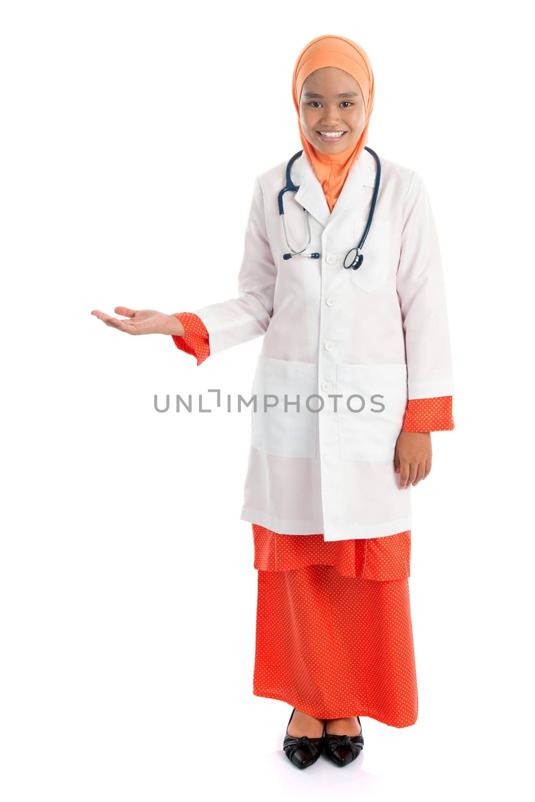 Full body young Muslim female doctor portrait, showing welcome hand sign standing isolated on white background.