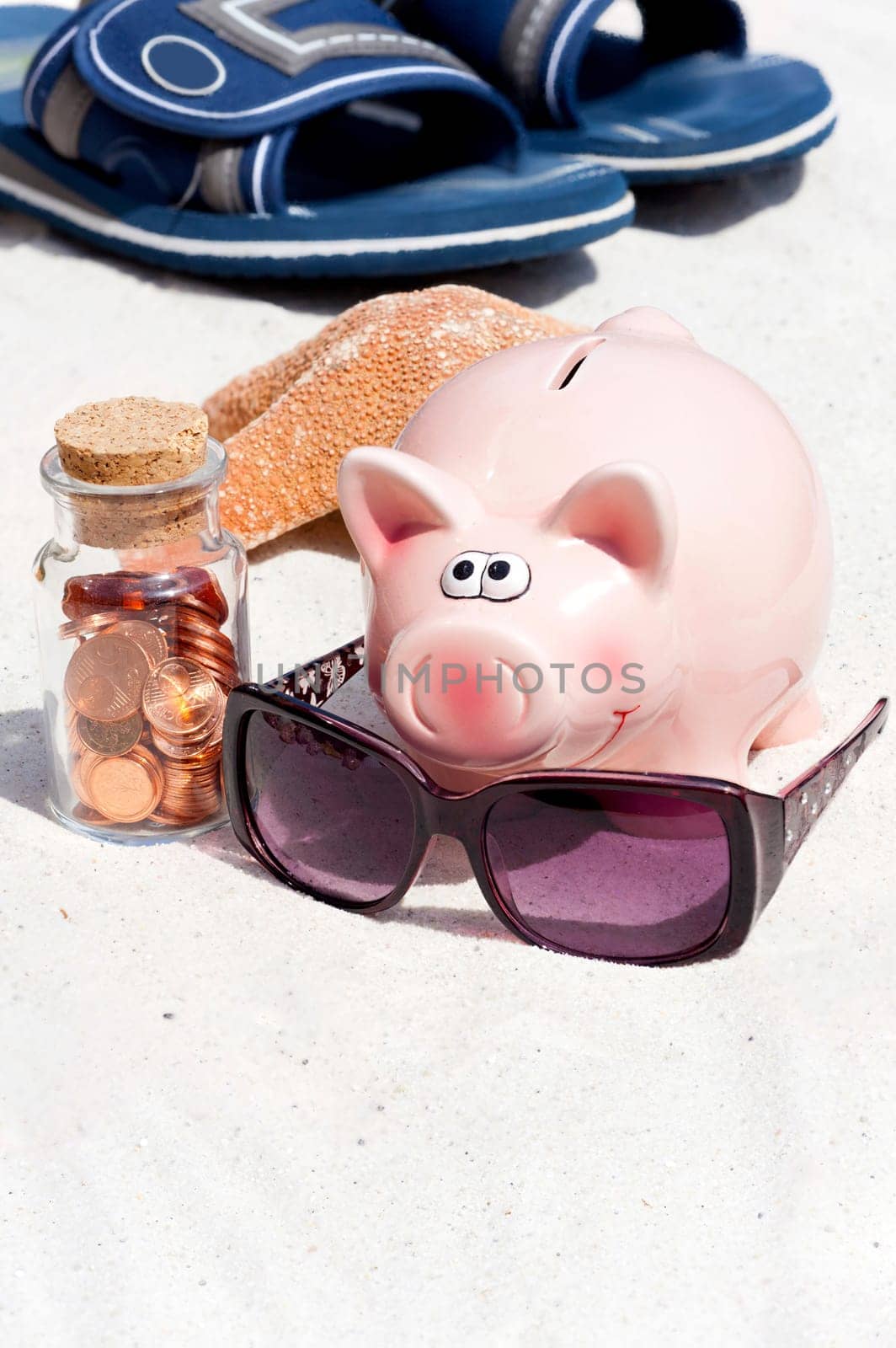 Piggy bank and coins on the beach,save for holidays