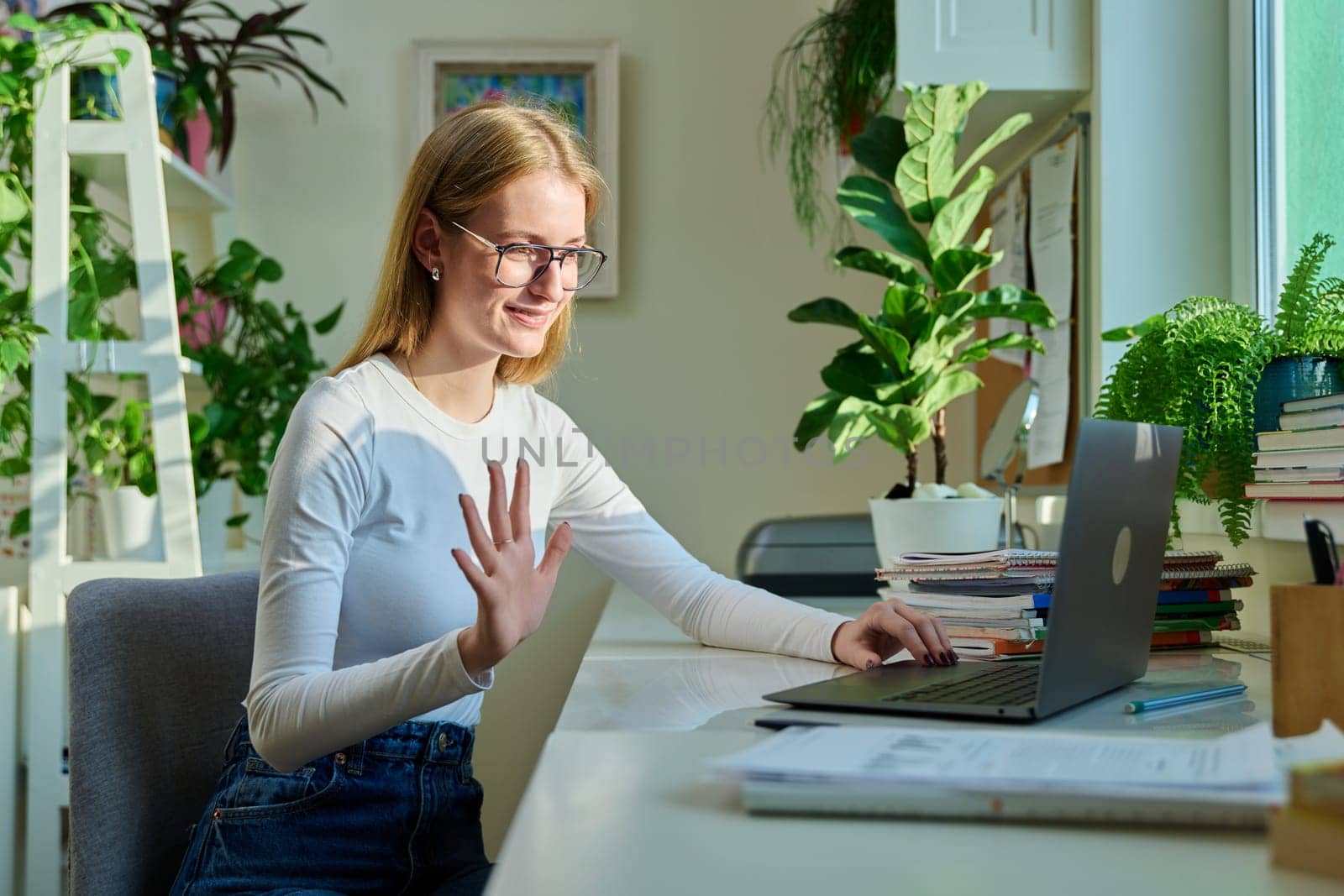 Teenage girl high school student having video conference on laptop computer at home, remote lesson learning language online lecture educational webinar. E-education knowledge adolescence technology