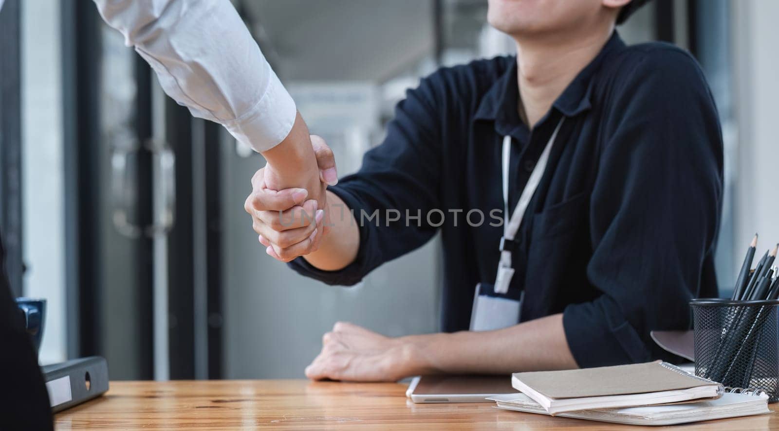 Handshake of cooperation customer and salesman after agreement, successful car loan contract buying or selling new vehicle.