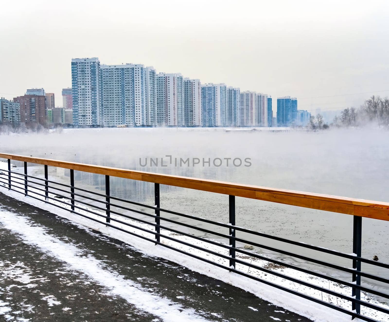 Waterfront walkway on right bank of Yenisey river. View on residential district in Krasnoyarsk city.