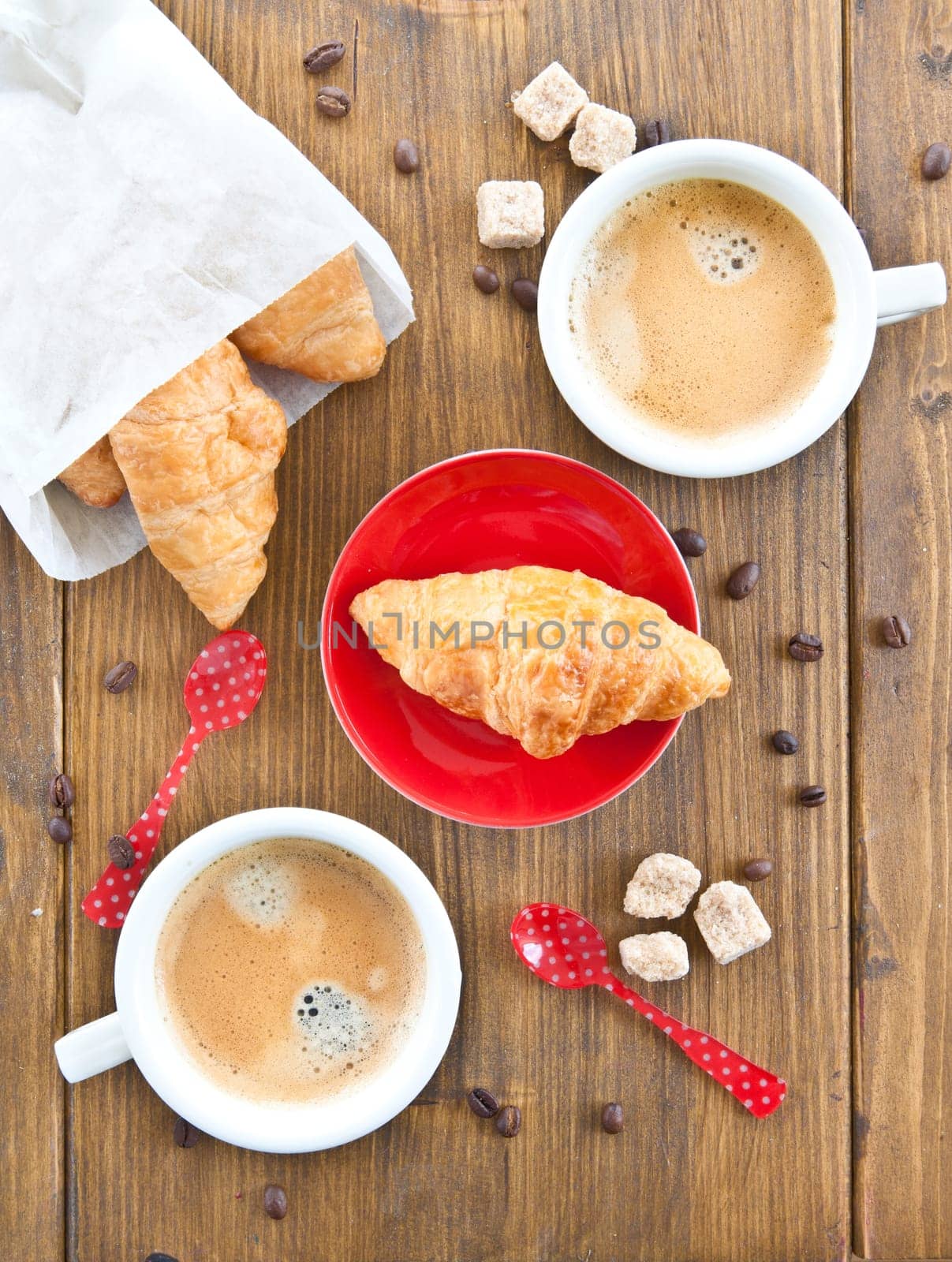 Cups with coffee and fresh croissants