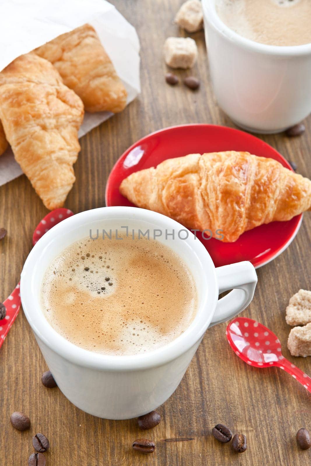 Cups with coffee and fresh croissants