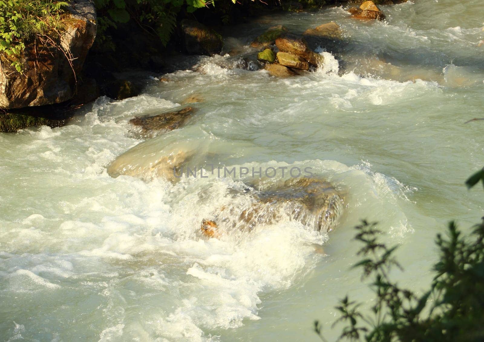 Small brook with clear white melting water