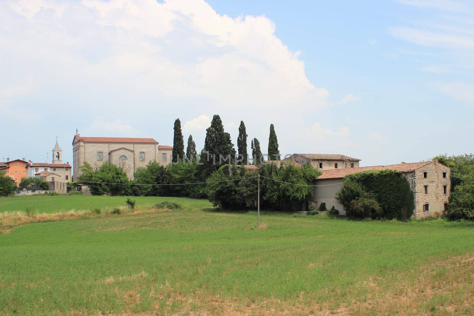 View over church and abandon vineyard in Italy