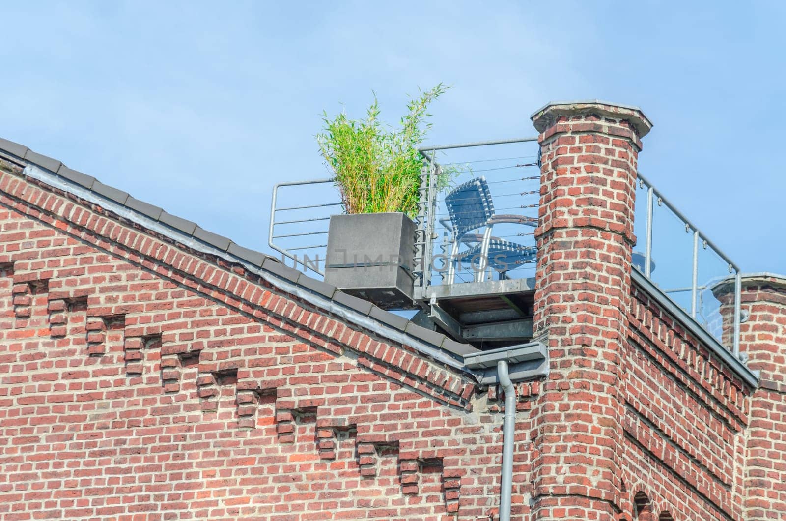 Beautiful renovated old building facade with an Idiylian roof terrace.