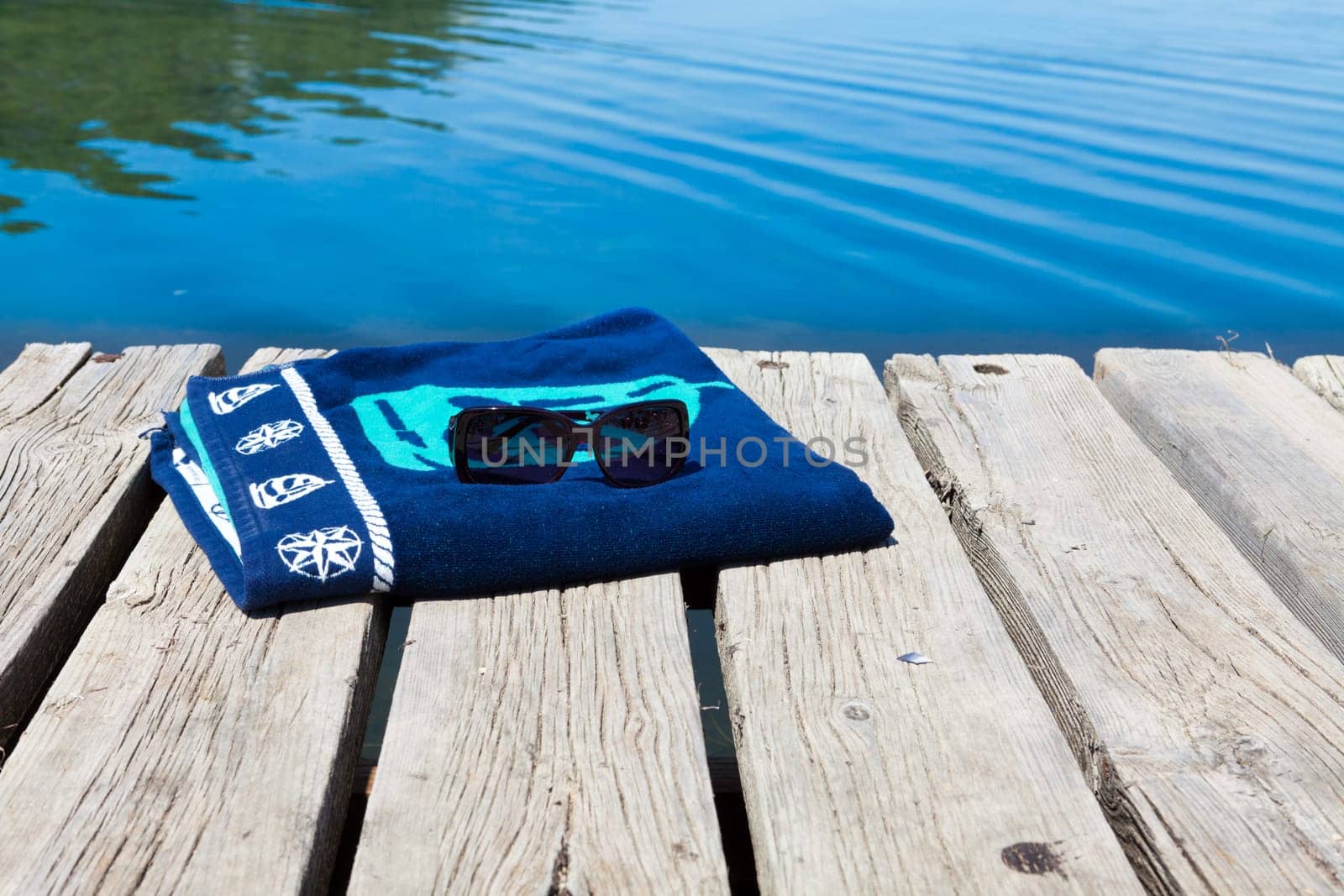 Bath towel and sunglasses on an old bathing jetty