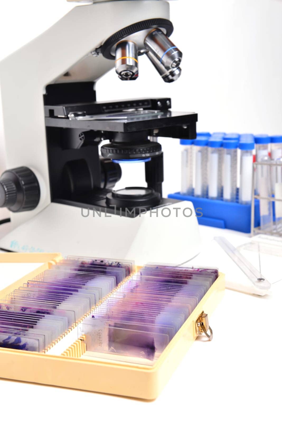 microscope with laboratory equipment on white background