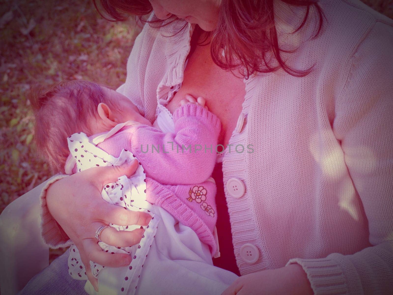 Pretty young brunette mum breastfeeding her baby