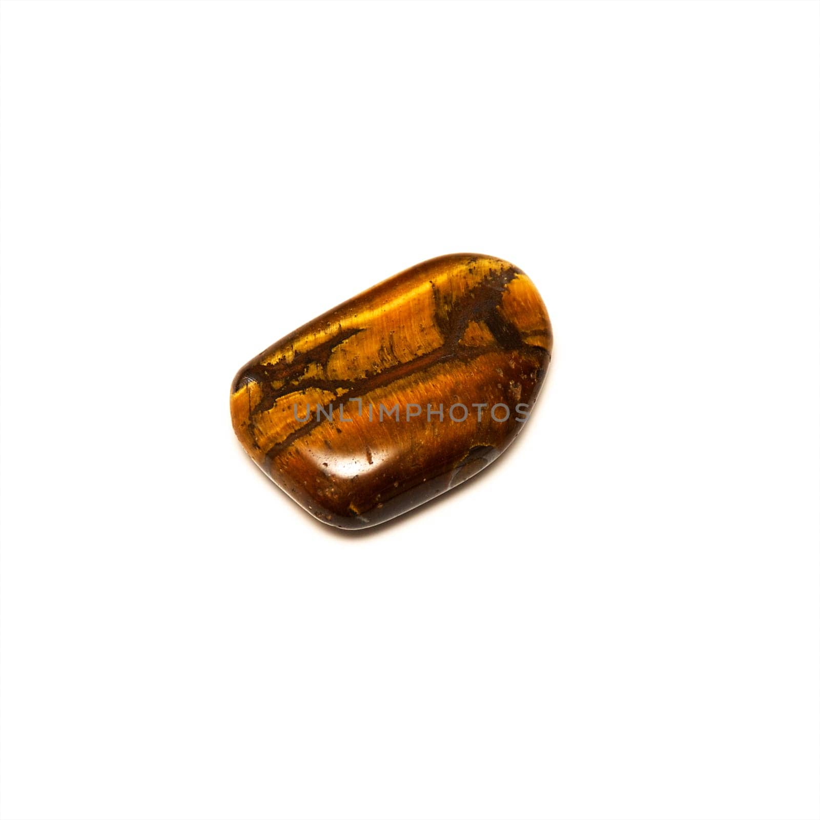 An iridescent tiger's eye stone showing varied colors of brown, shot over white.