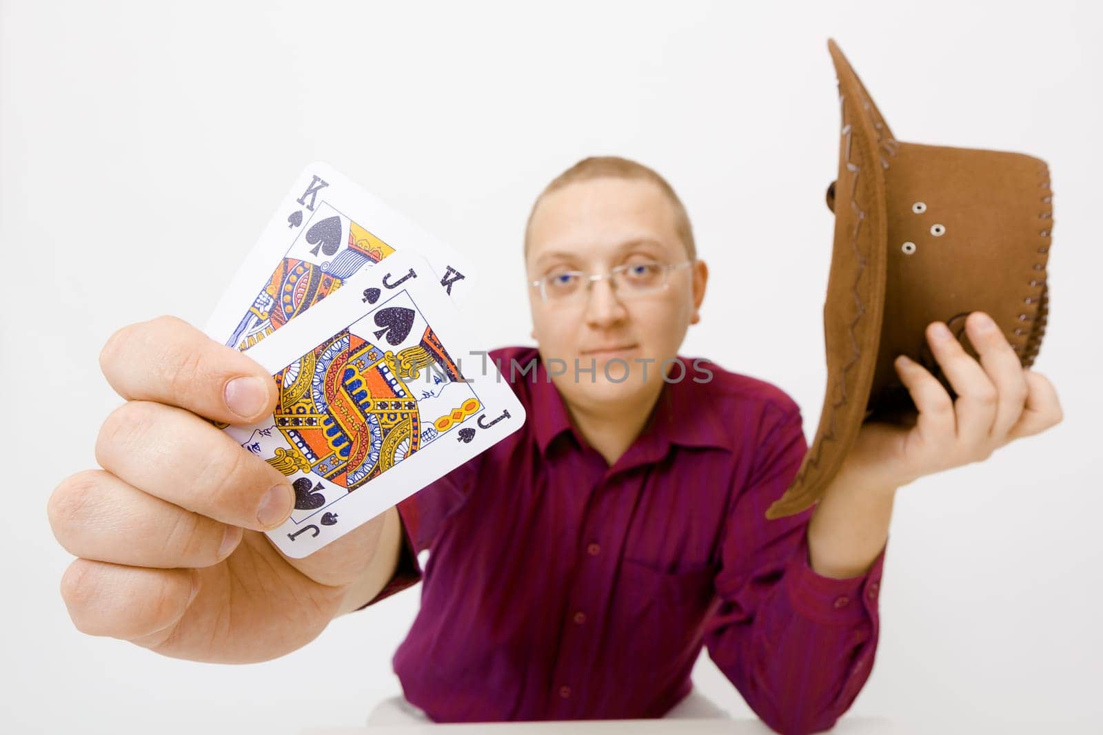 Man holding hat and two cards