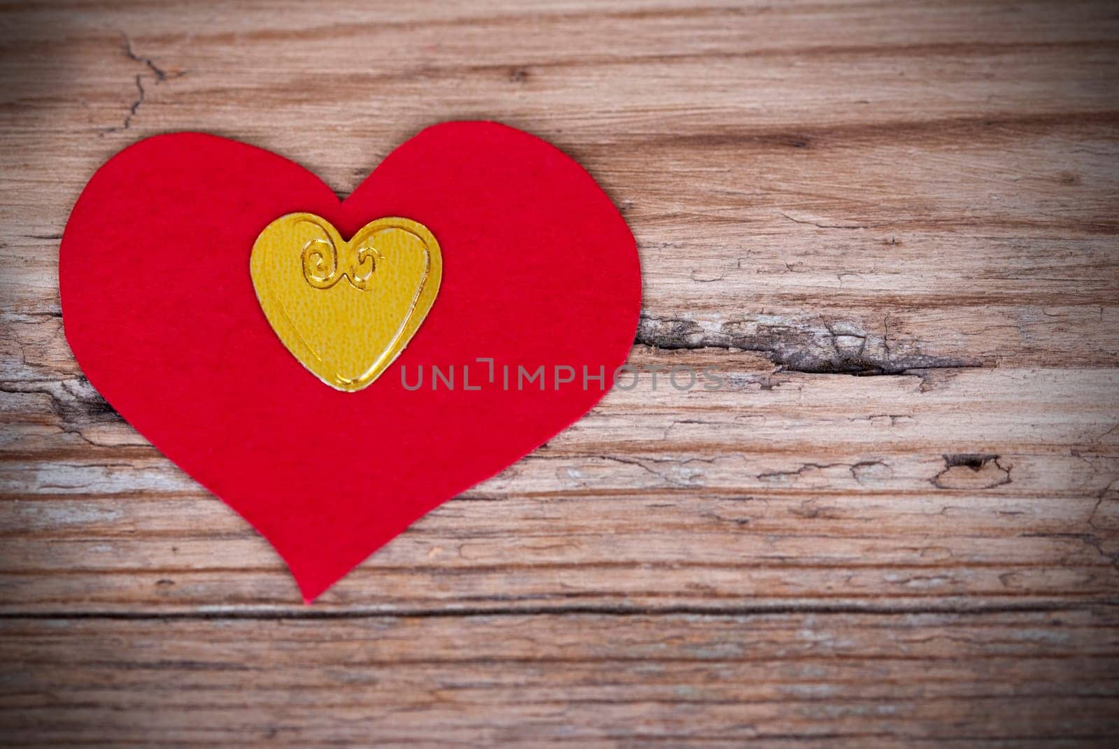 Two Hearts, a Red and a Golden One, on a Wooden Plank