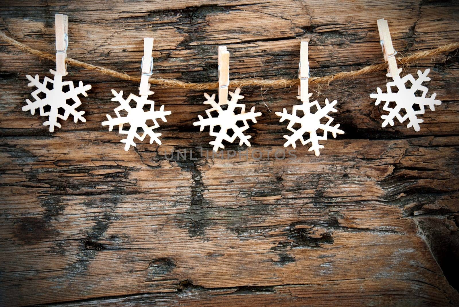 Christmas or Winter Background with Snowflakes on a Line on Wood